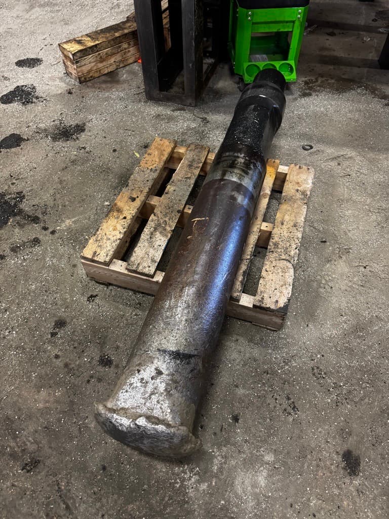 D175 breaker tool with a severely mushroomed tip, resting on a pallet